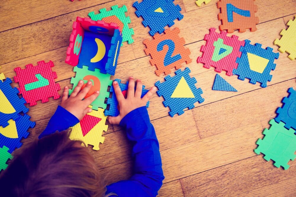 Little Girl Playing With Puzzle